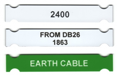2 white and 1 green laser cut and laser engraved electrical tags