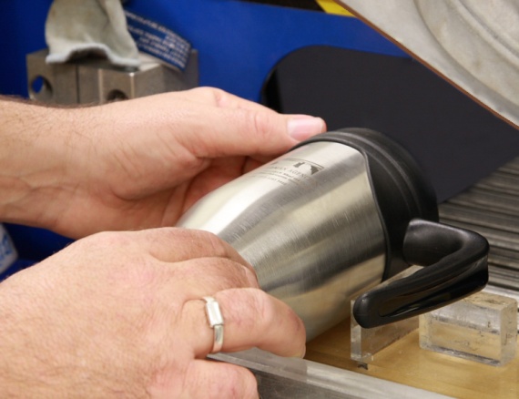 promotional cup being laser engraved